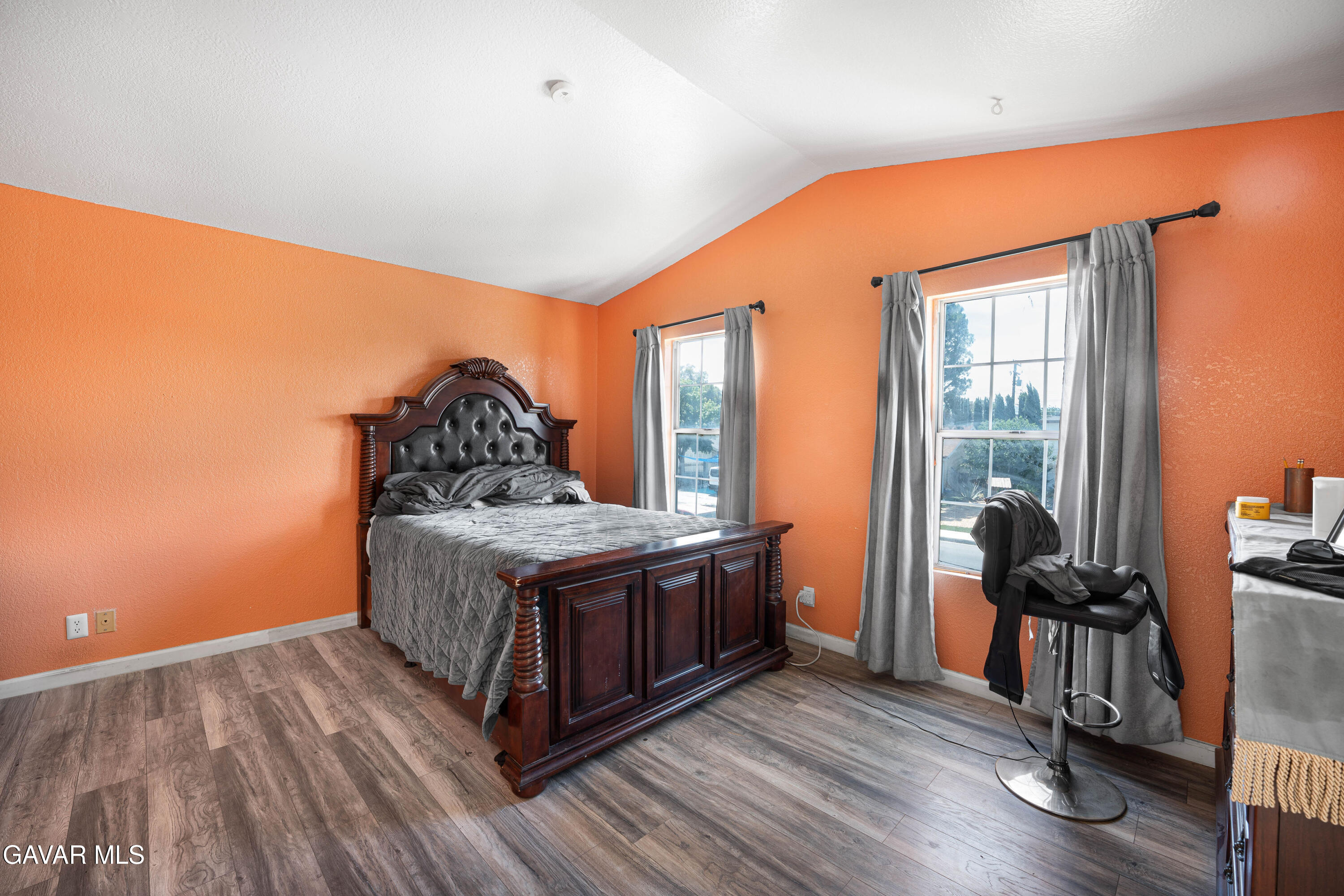 5009 East Ave R 11 Palmdale, CA 93552 - Photo 20 of 23 a bedroom with a bed and wooden floor