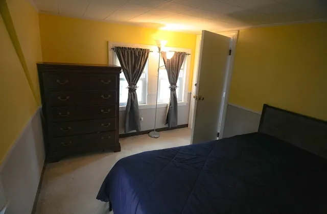 a bedroom with a bed and a walk in closet