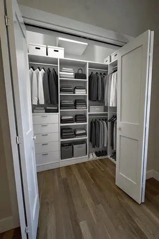 a view of walk in closet with empty racks