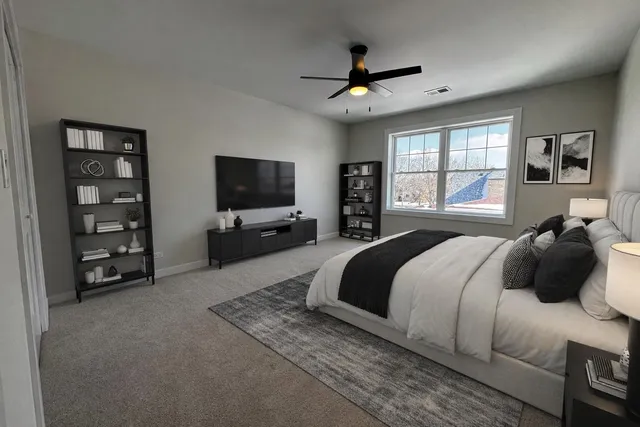 a bedroom with a bed window and a flat screen tv