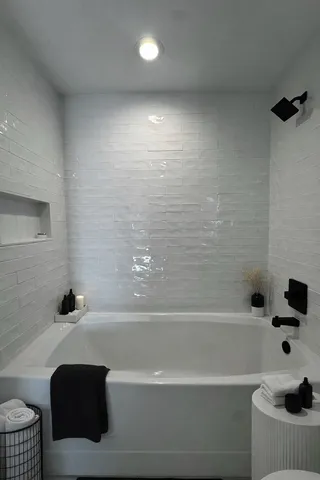 a bathroom with a bathtub and shower