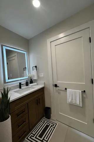 a bathroom with a double vanity sink a and a mirror