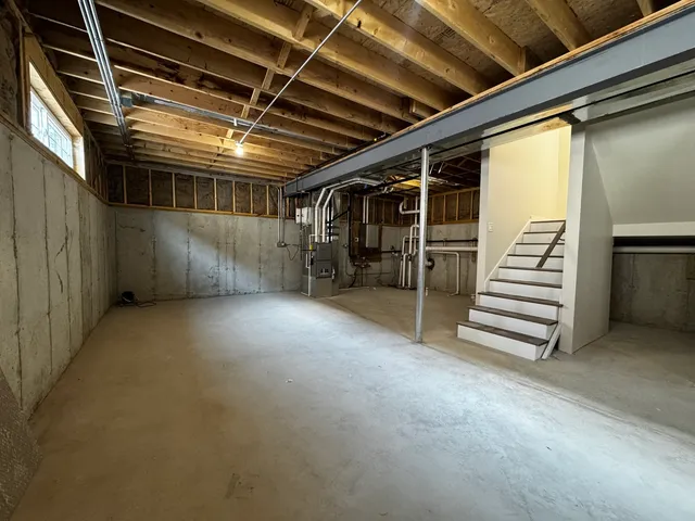 a view of empty room with stairs and mirrors