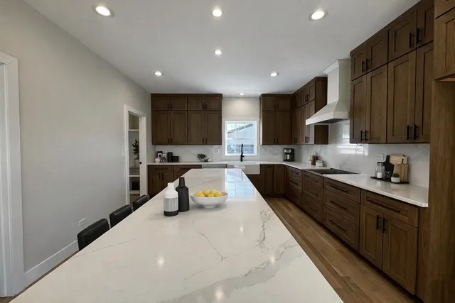 a kitchen with a sink a counter top space a stove and cabinets