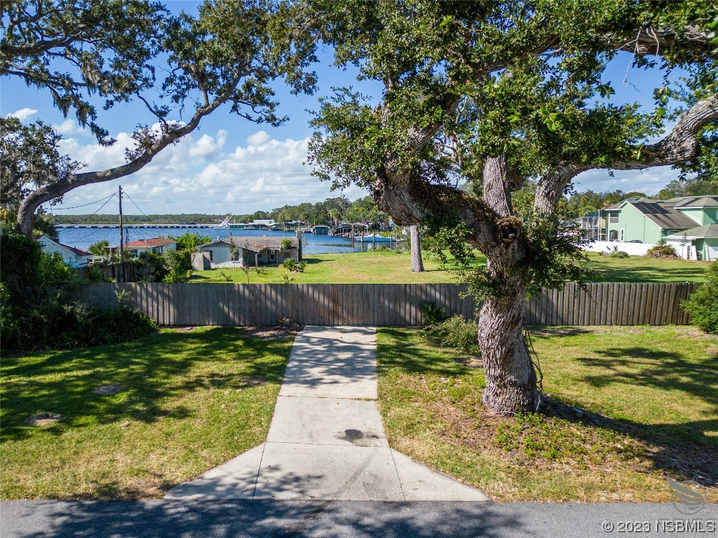 5952 Riverside Drive Port Orange, FL 32127 - Photo 6 of 27 a view of a lake with a house in the background