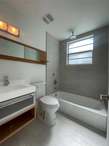 a bathroom with a sink a toilet and bathtub