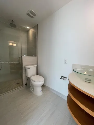 a bathroom with a toilet a sink and shower