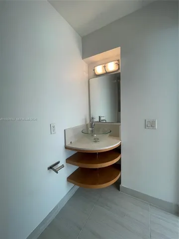 a room with a sink and a mirror