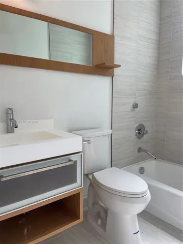 a bathroom with a toilet a sink and bathtub