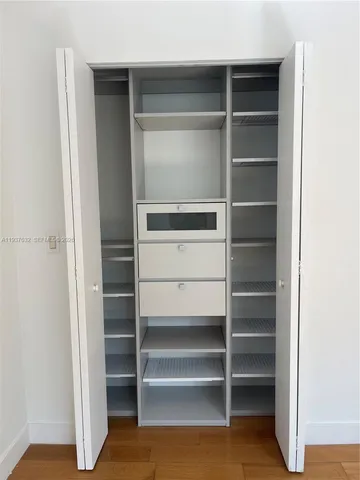 a view of walk in closet with empty racks