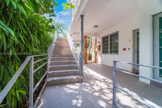 a view of house with stairs and wooden floor