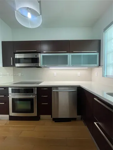 a kitchen with a stove and a microwave