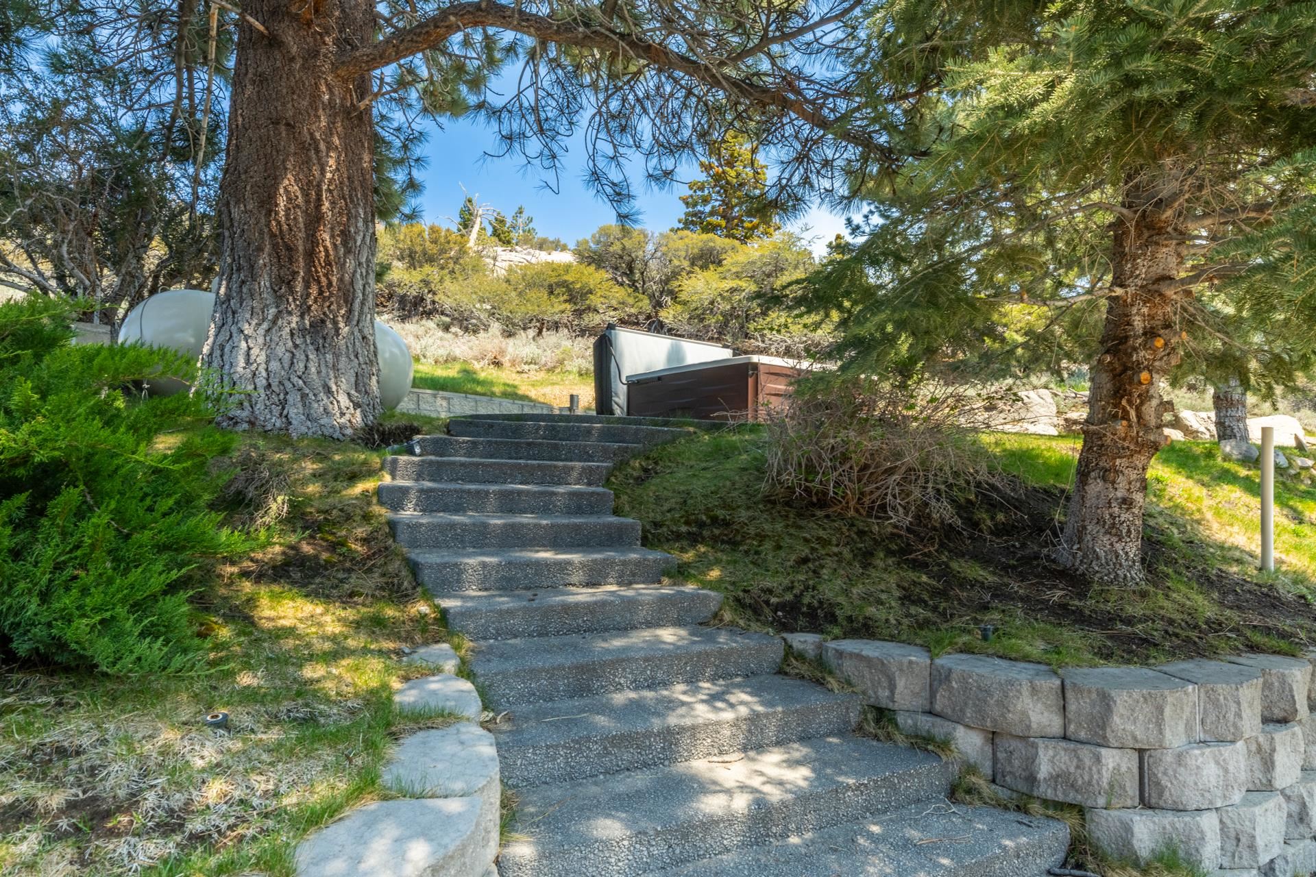 45 Skyline Road June Lake, CA 93529 - Photo 46 of 58 Concrete steps ascend a landscaped hillside, bordered by a stone retaining wall