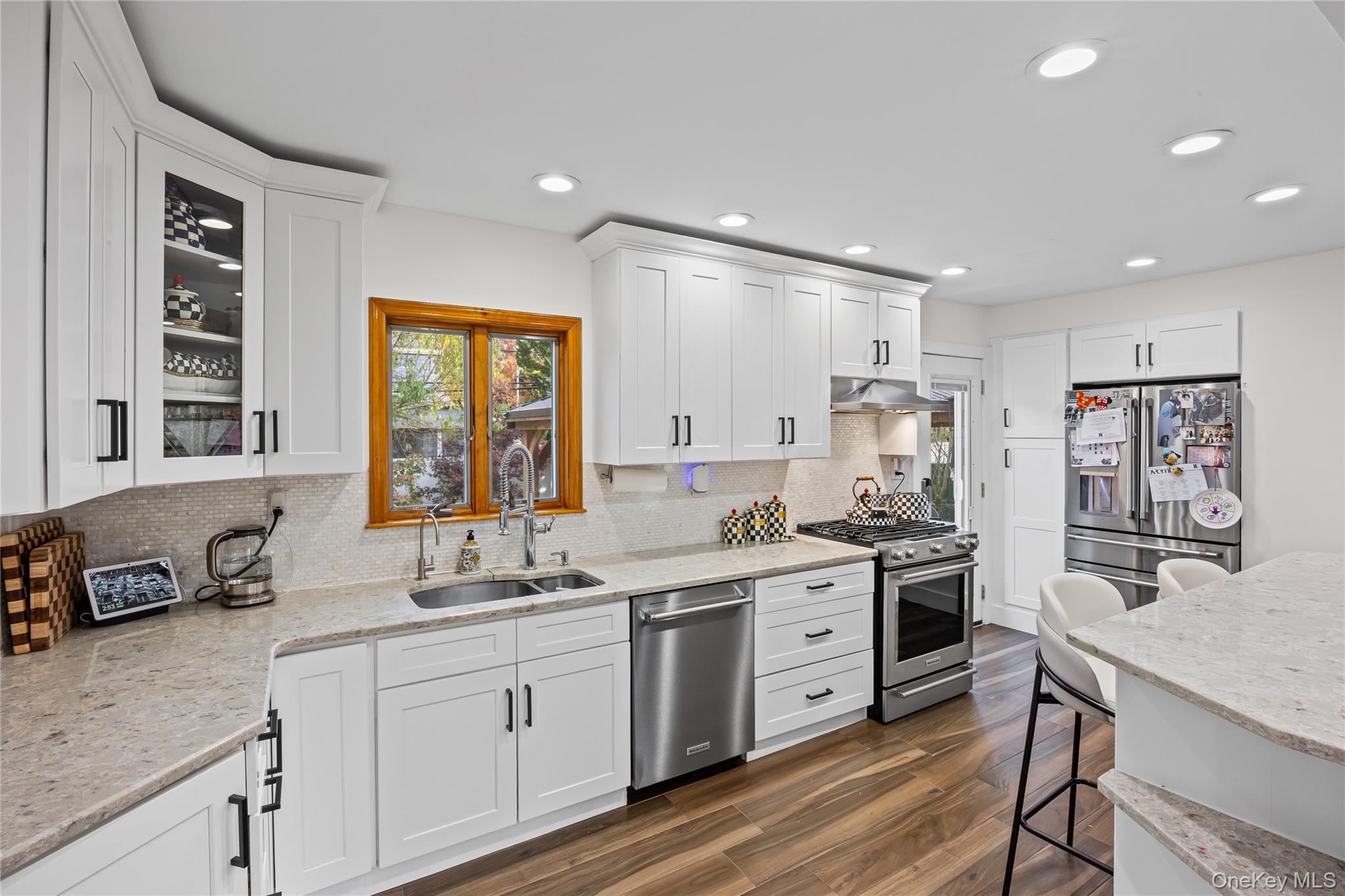 8 Willow Road New Hyde Park, NY 11040 - Photo 7 of 34 a kitchen with a sink stove and cabinets