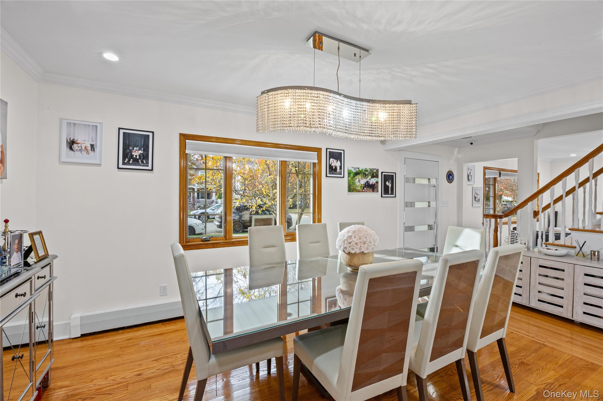 8 Willow Road New Hyde Park, NY 11040 - Photo 9 of 34 a view of a dining room with furniture a chandelier and wooden floor