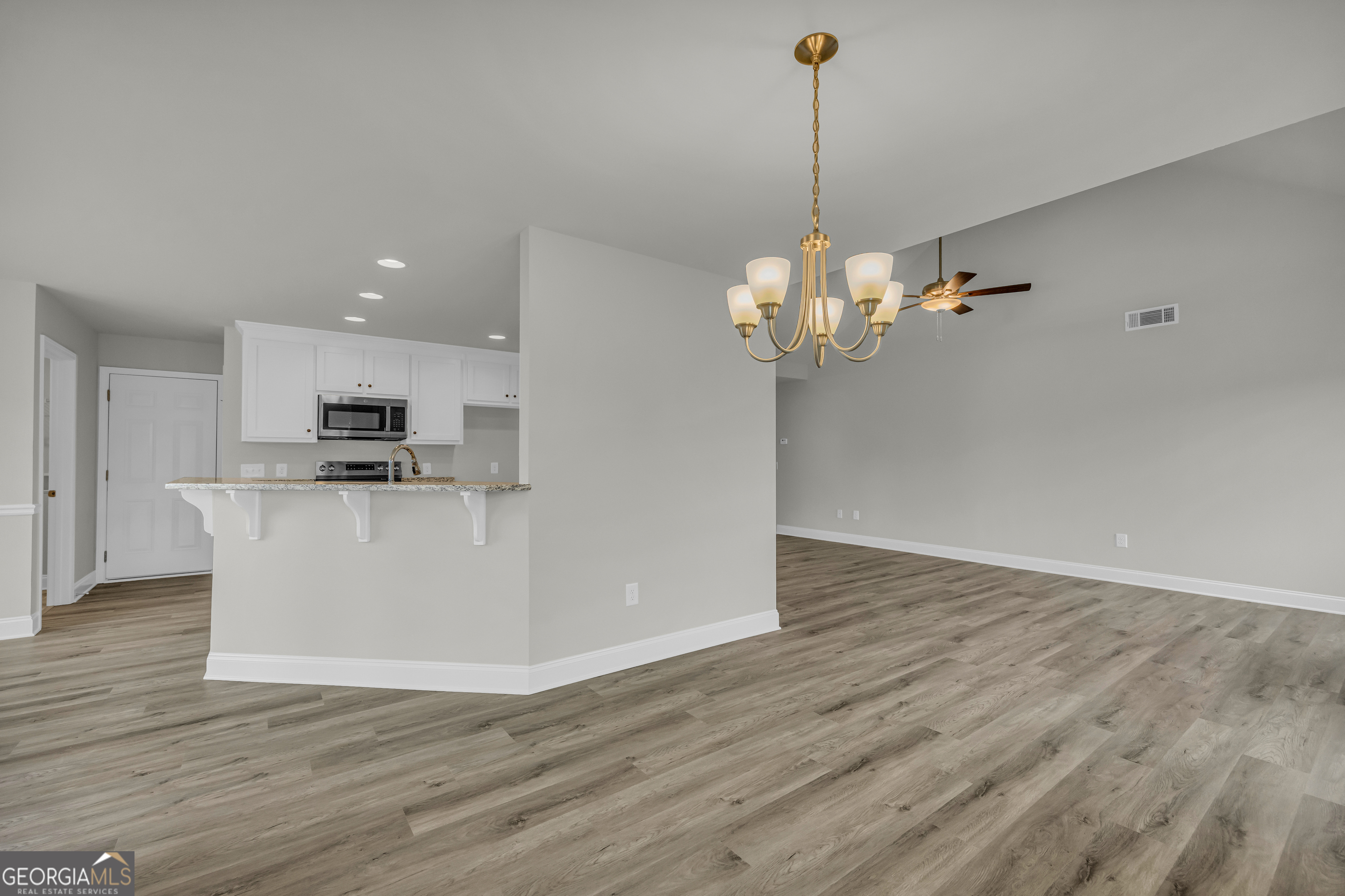 86 Sewell Road Lavonia, GA 30553 - Photo 15 of 67 a view of a kitchen with a dishwasher cabinets and wooden floor