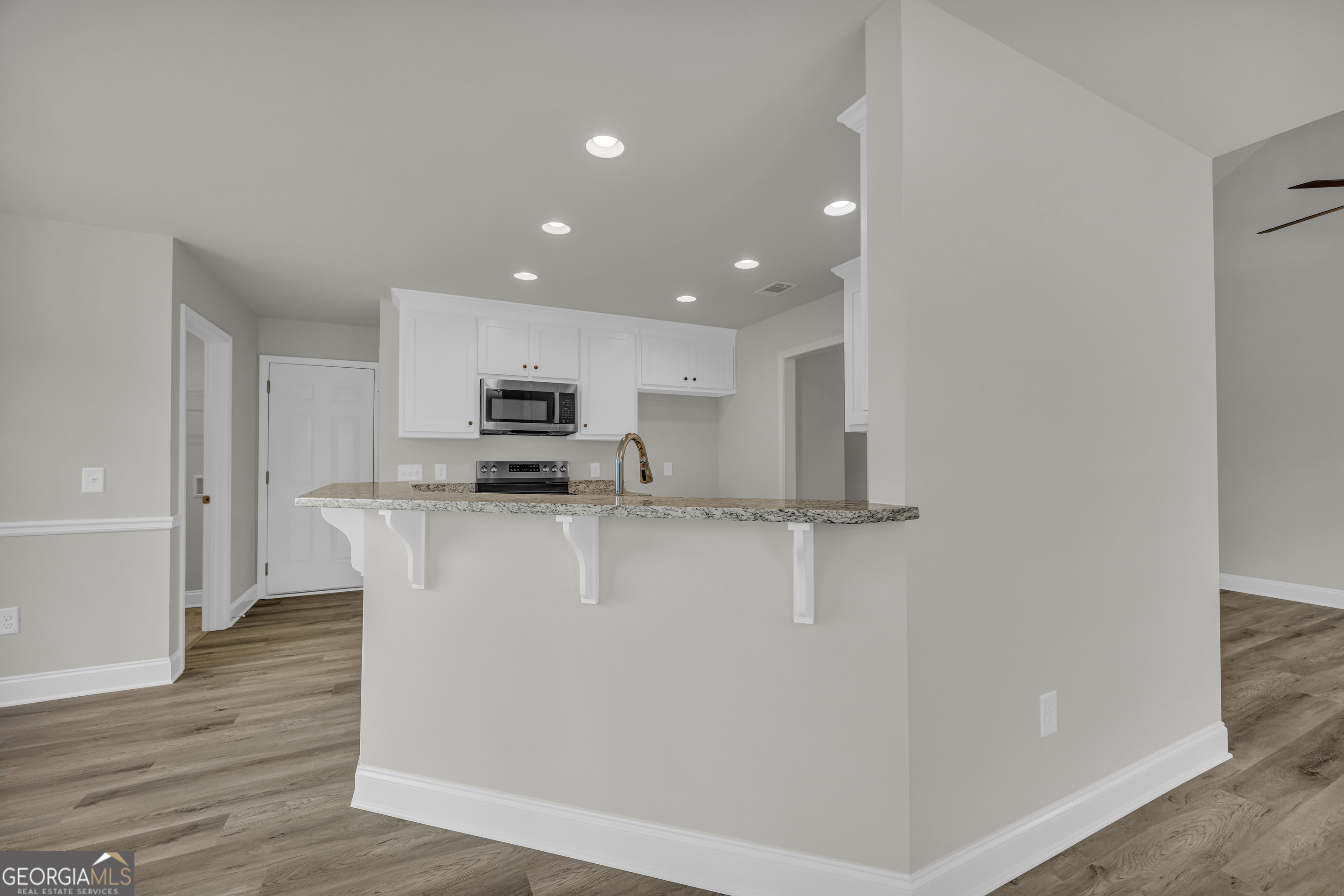 86 Sewell Road Lavonia, GA 30553 - Photo 17 of 67 a kitchen with stainless steel appliances granite countertop a refrigerator a stove top oven a sink and dishwasher