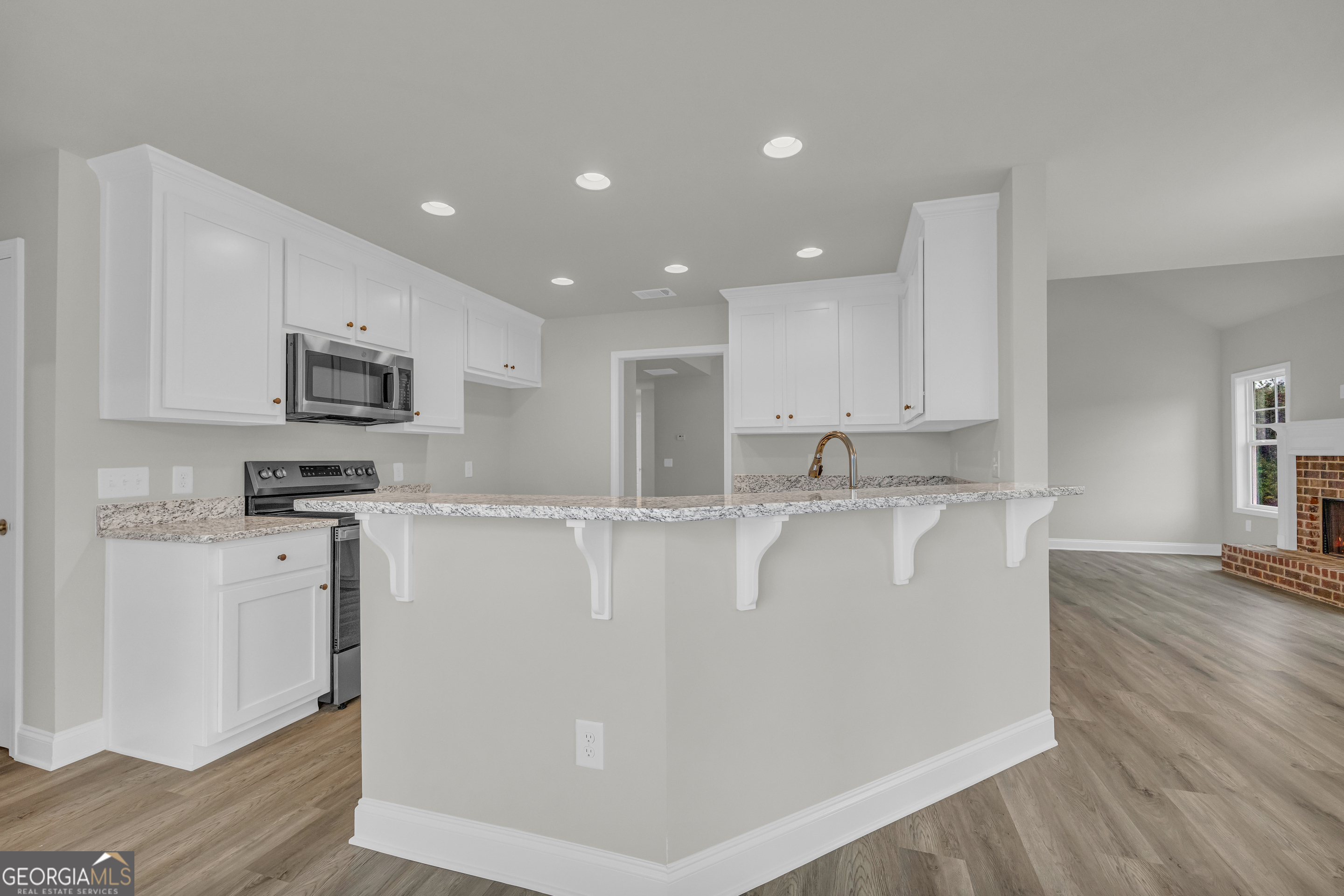 86 Sewell Road Lavonia, GA 30553 - Photo 22 of 67 a view of kitchen with stainless steel appliances granite countertop a stove a sink a refrigerator and white cabinets with wooden floor