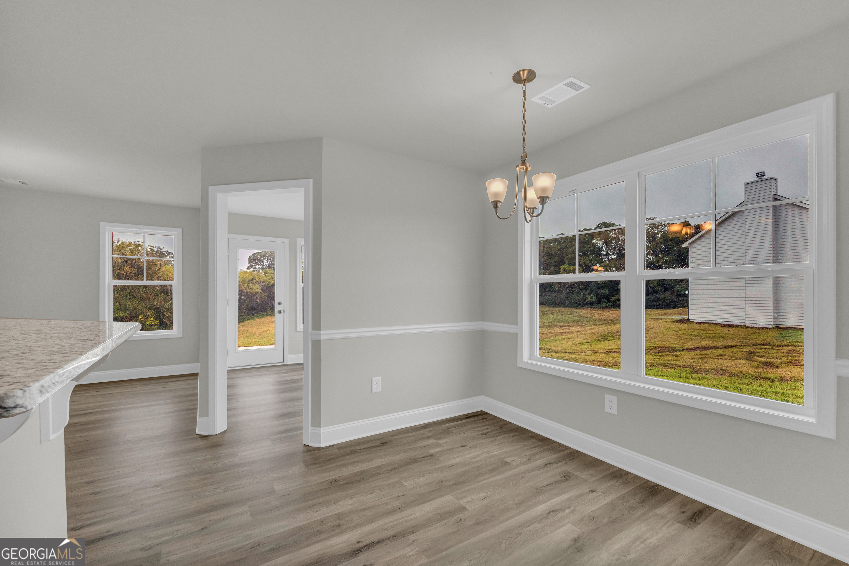 86 Sewell Road Lavonia, GA 30553 - Photo 23 of 67 a view of empty room with wooden floor and fan