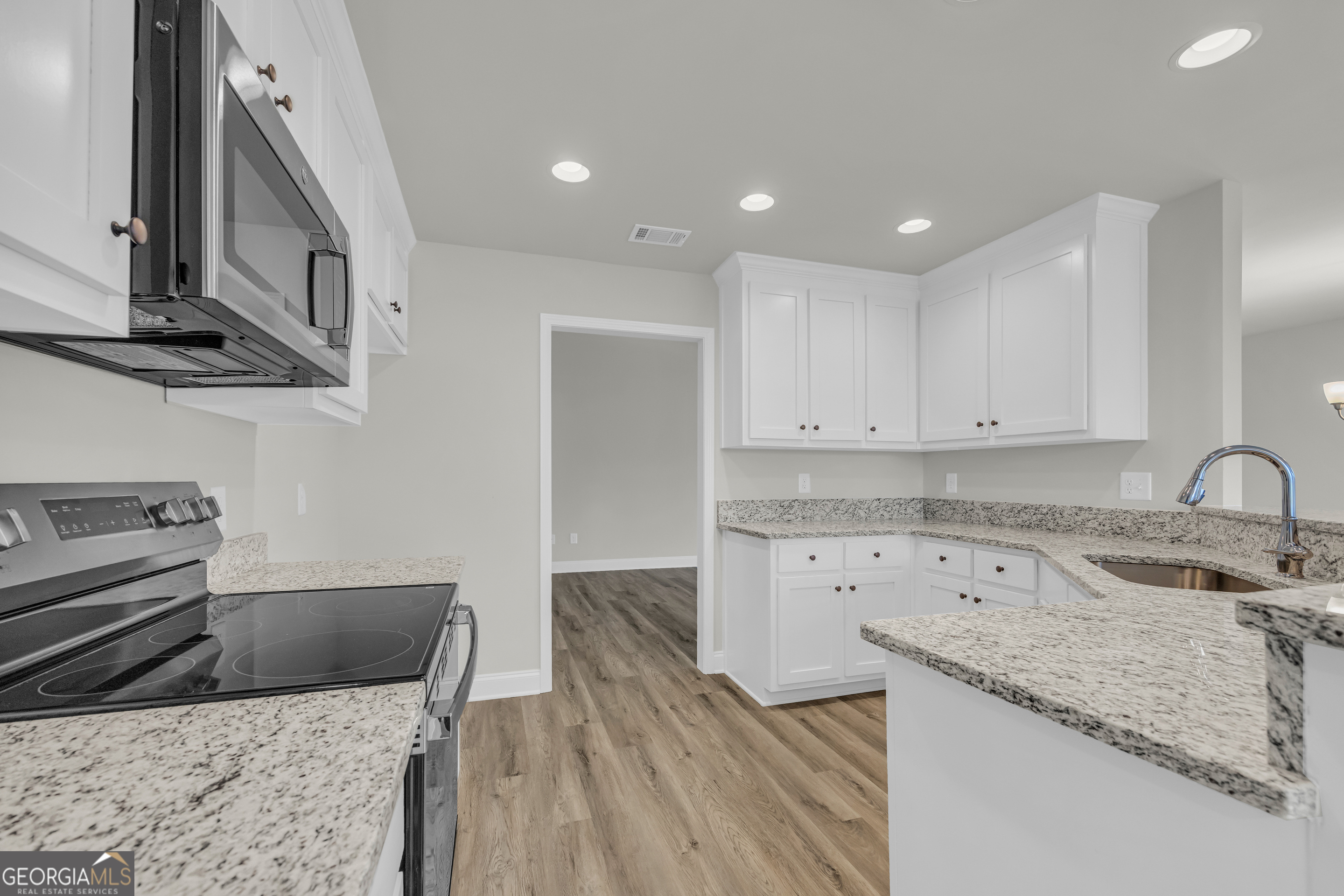 86 Sewell Road Lavonia, GA 30553 - Photo 28 of 67 a kitchen with granite countertop a sink a stove and cabinets
