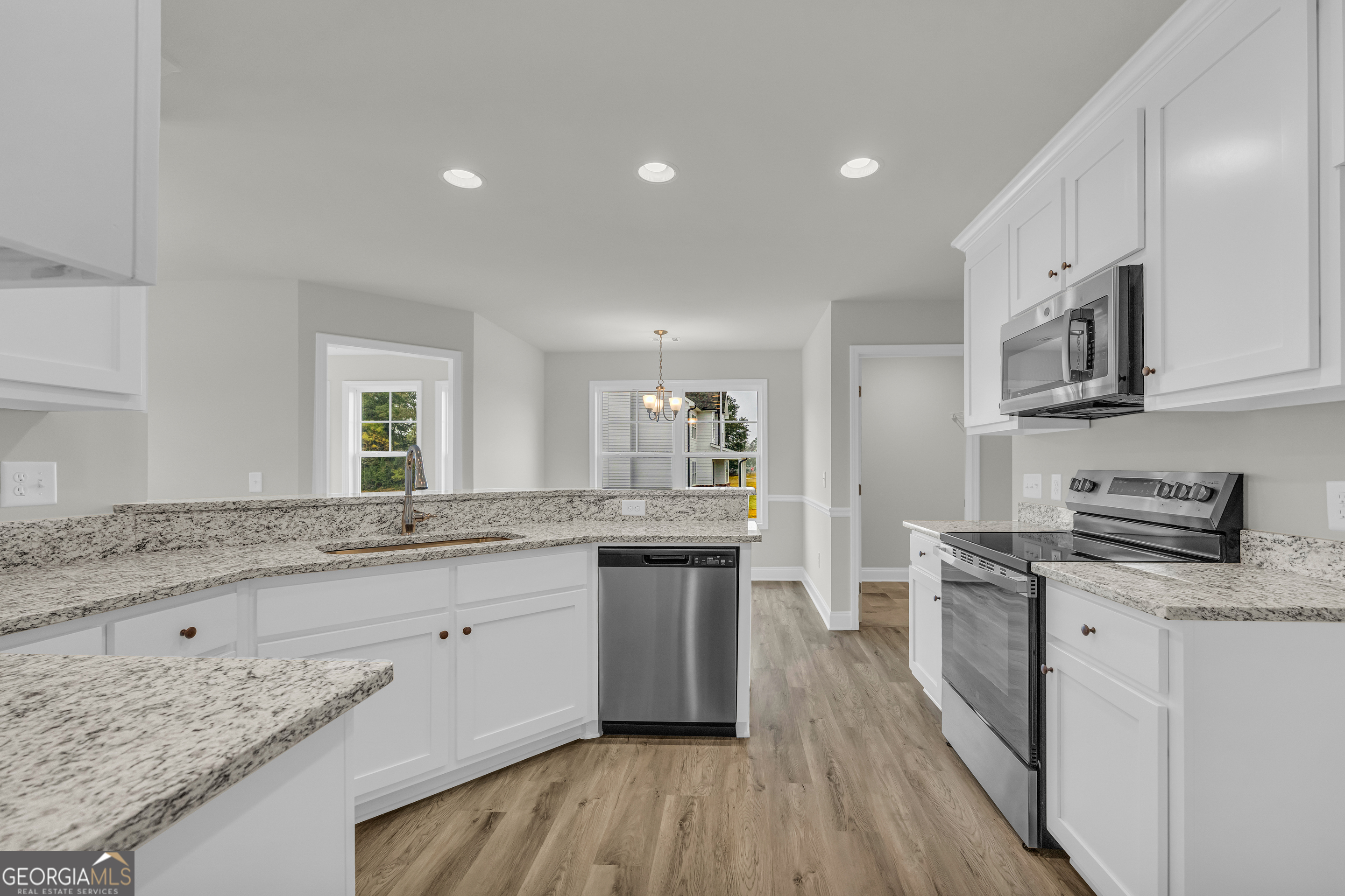 86 Sewell Road Lavonia, GA 30553 - Photo 29 of 67 a large kitchen with stainless steel appliances granite countertop a stove top oven a sink a counter space and cabinets