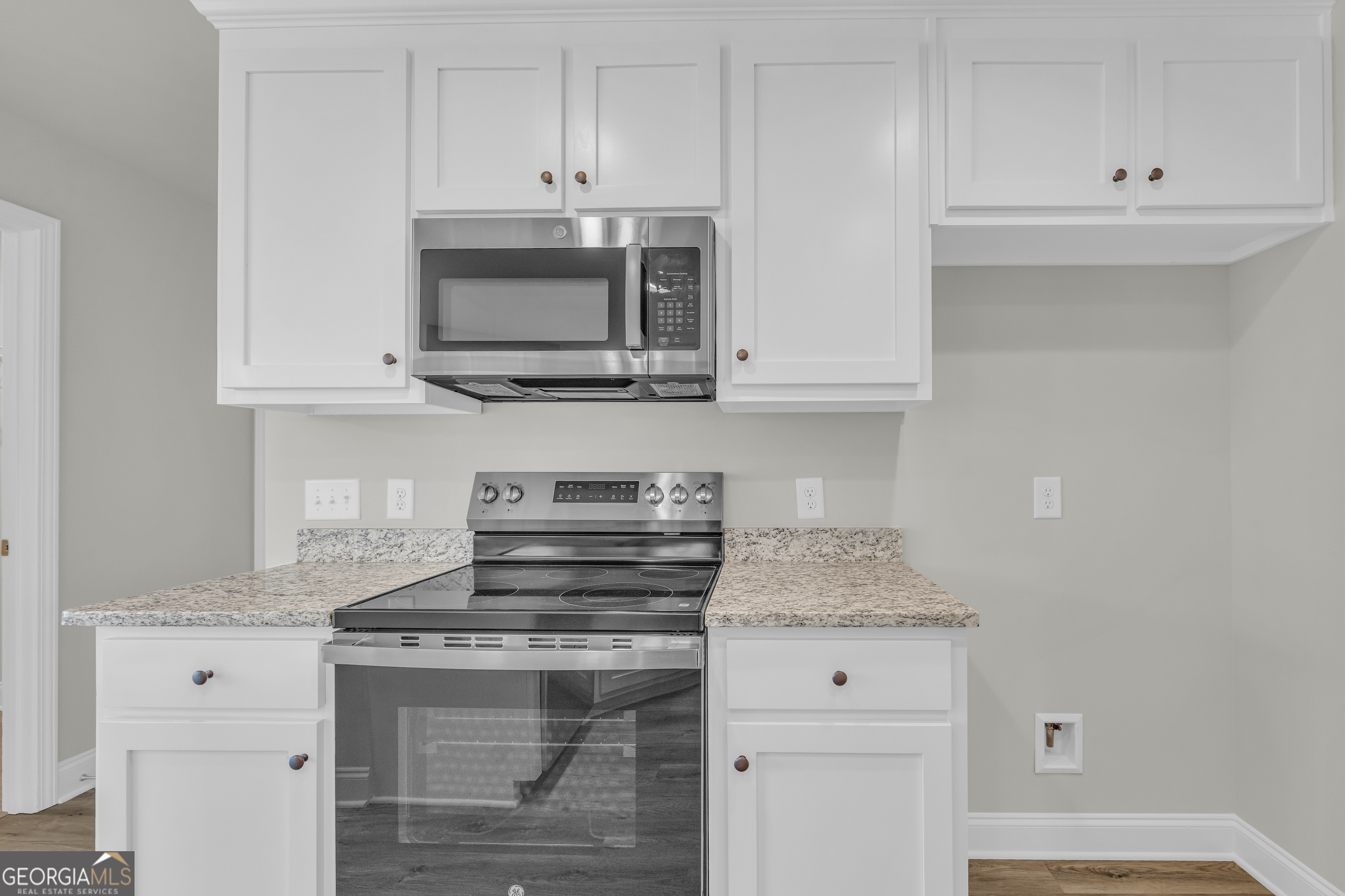 86 Sewell Road Lavonia, GA 30553 - Photo 31 of 67 a kitchen with stainless steel appliances granite countertop a stove and a white cabinets