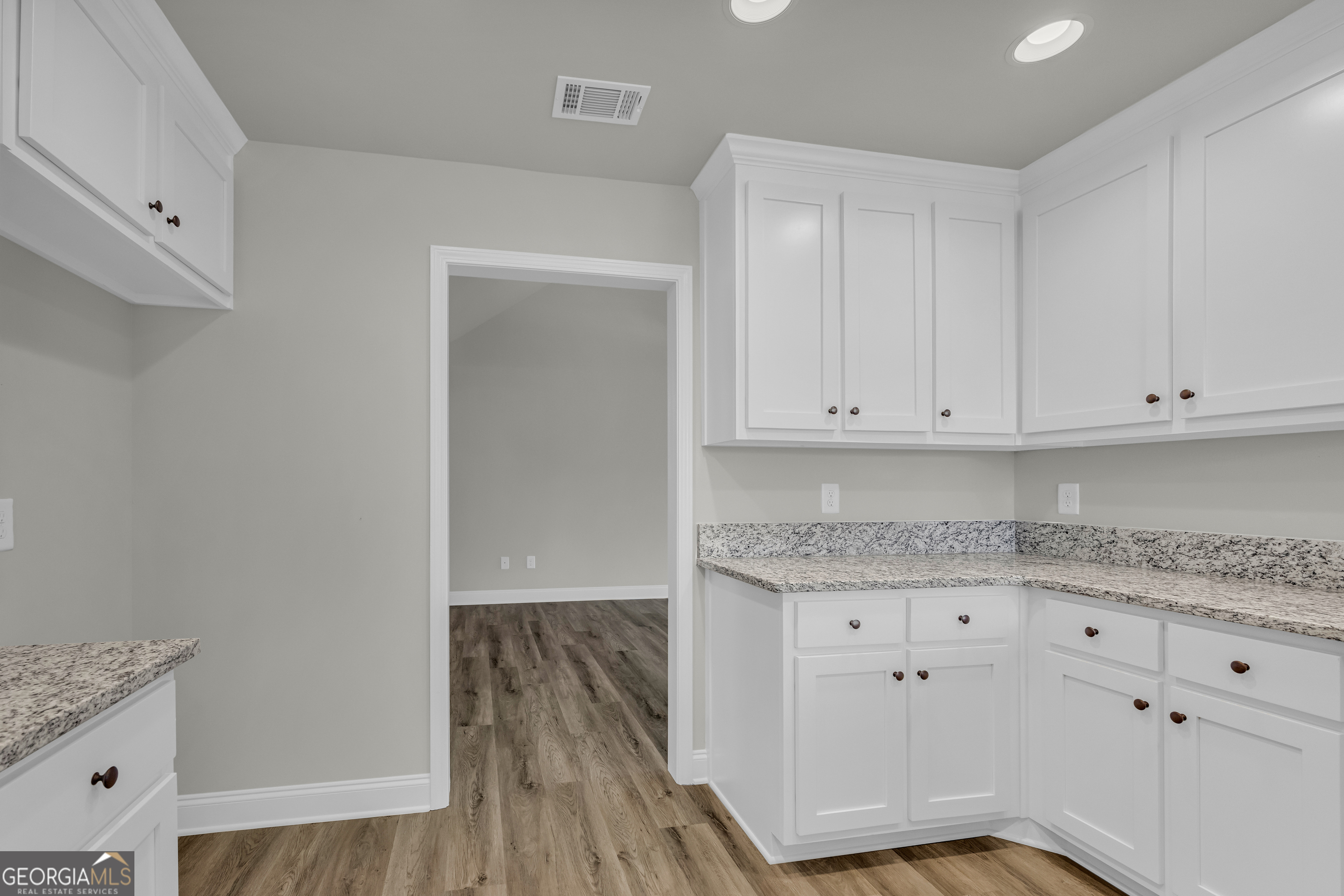 86 Sewell Road Lavonia, GA 30553 - Photo 32 of 67 a kitchen with granite countertop white cabinets and white appliances
