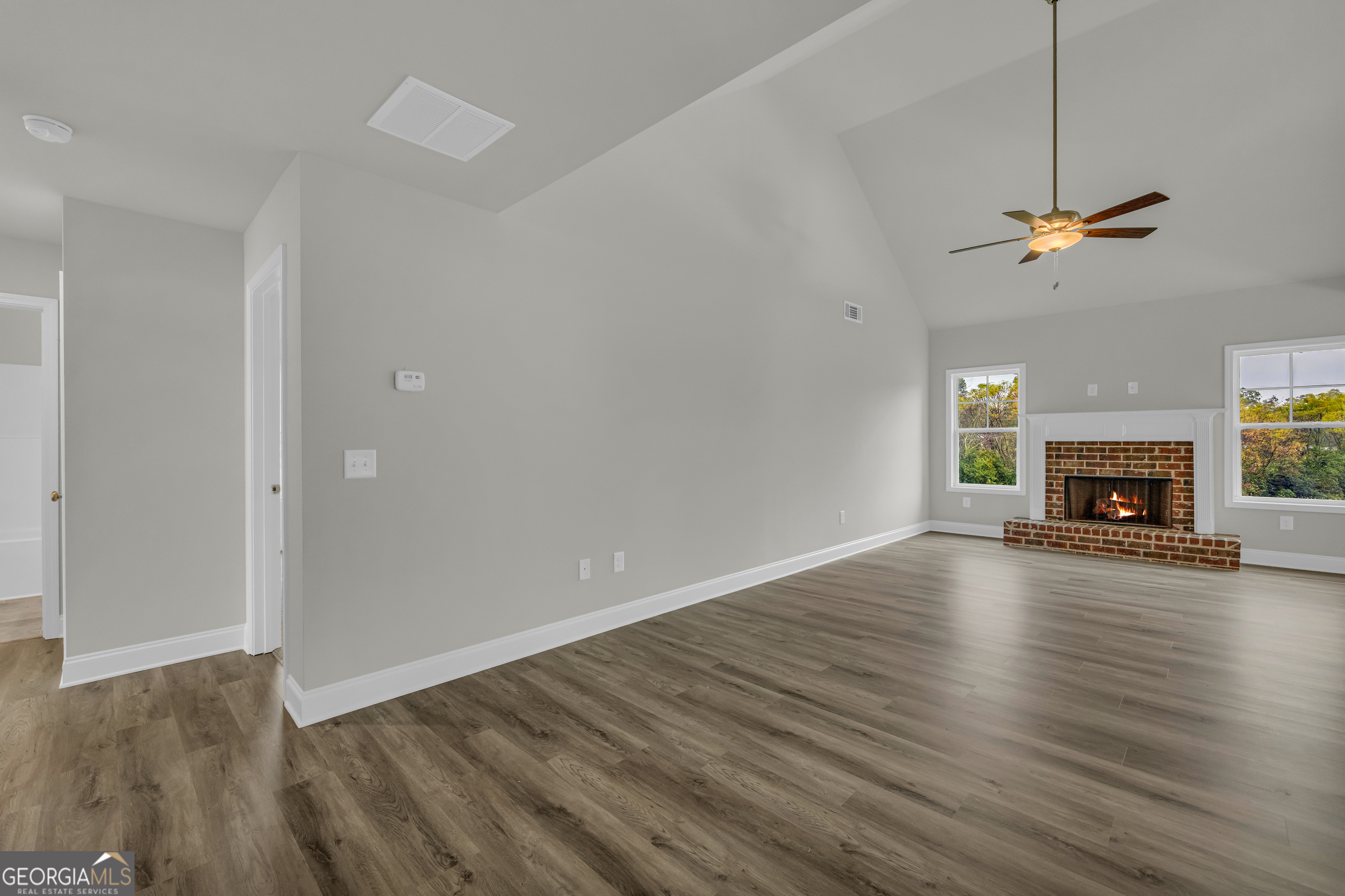 86 Sewell Road Lavonia, GA 30553 - Photo 4 of 67 a view of empty room with wooden floor fireplace and window