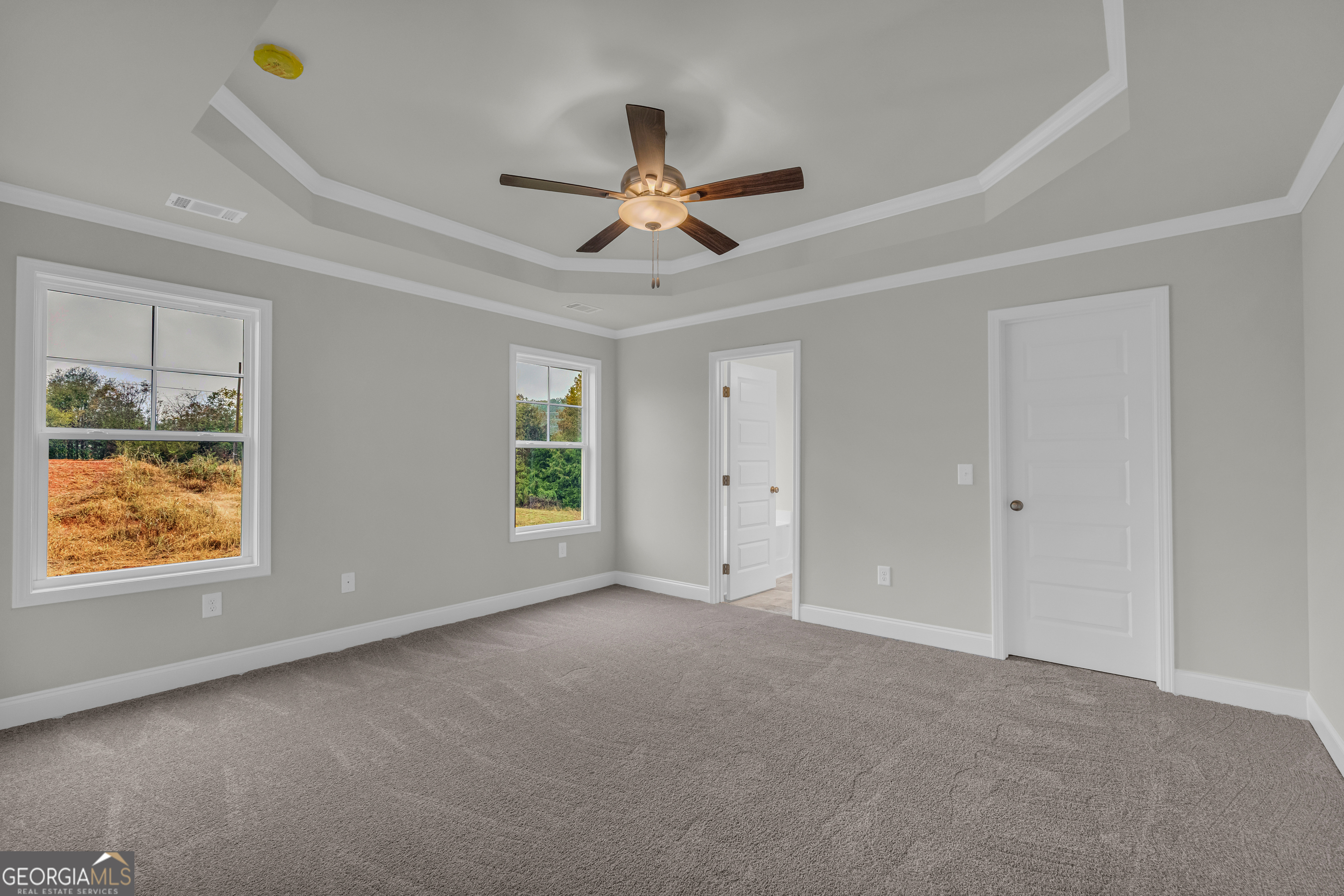 86 Sewell Road Lavonia, GA 30553 - Photo 41 of 67 a view of an empty room with window ceiling fan and kitchen view