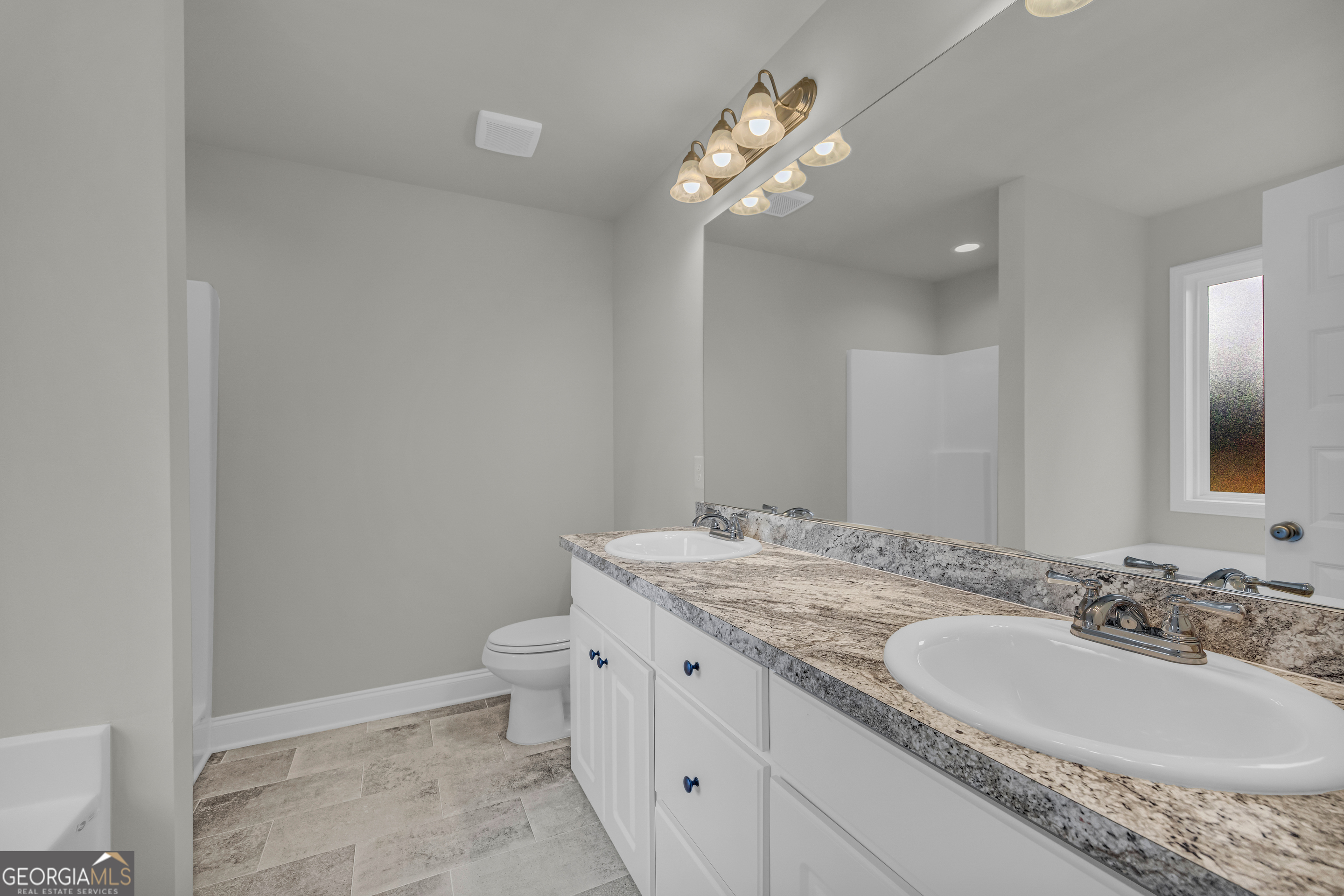 86 Sewell Road Lavonia, GA 30553 - Photo 44 of 67 a bathroom with a granite countertop sink a toilet and a mirror