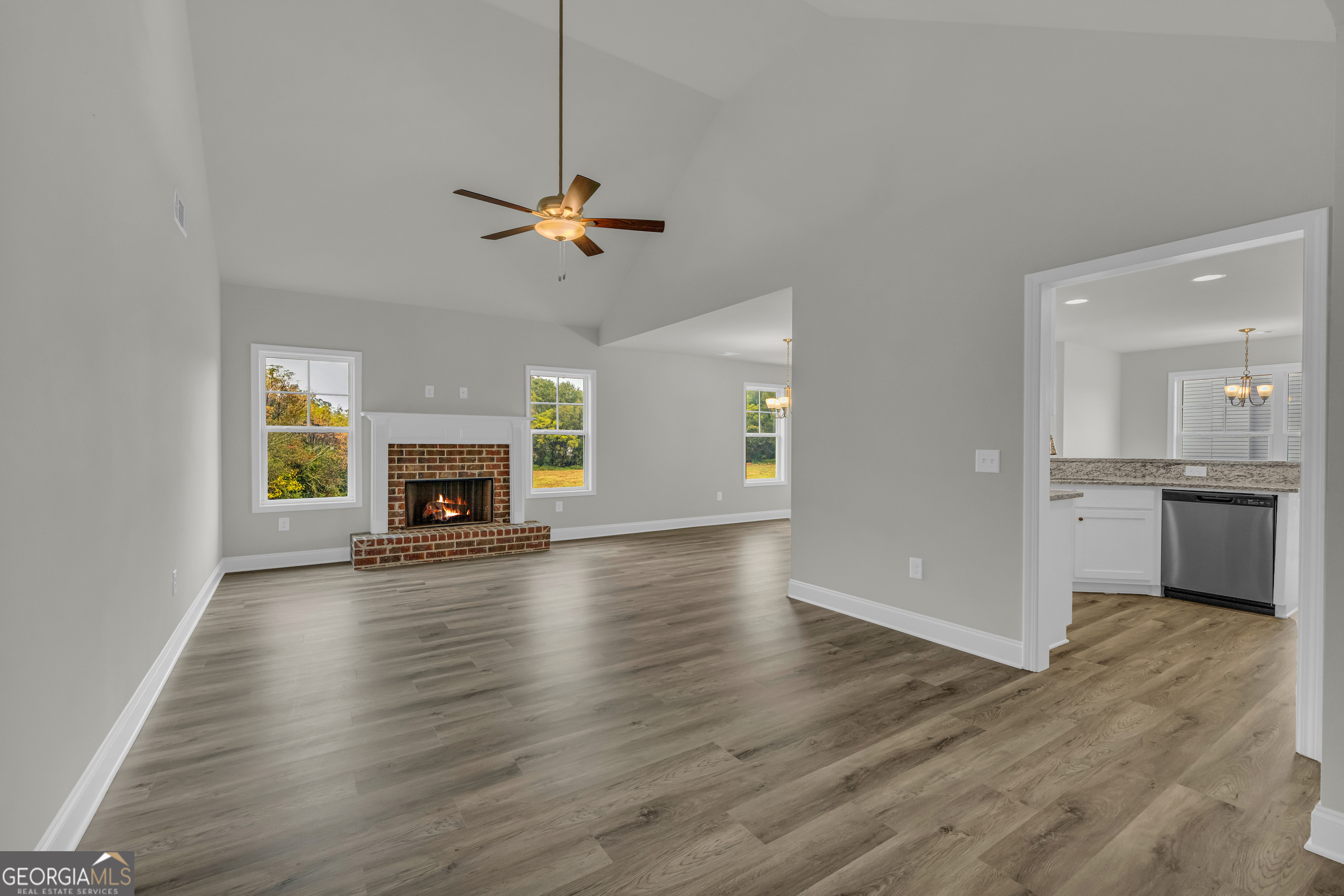 86 Sewell Road Lavonia, GA 30553 - Photo 6 of 67 a view of empty room with wooden floor fireplace and a window