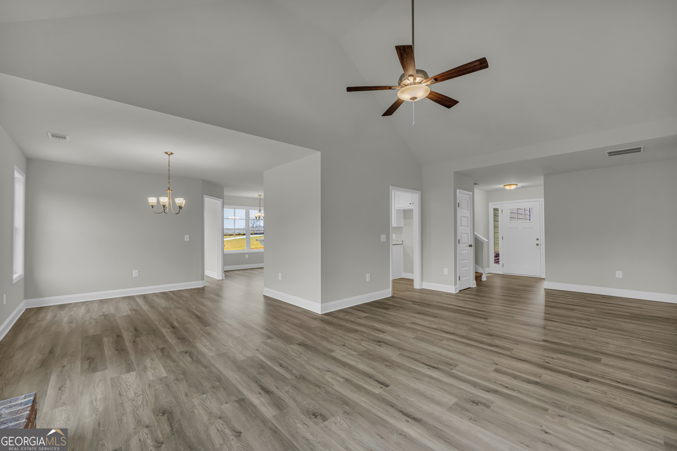 86 Sewell Road Lavonia, GA 30553 - Photo 7 of 67 a view of empty room with wooden floor and ceiling fan