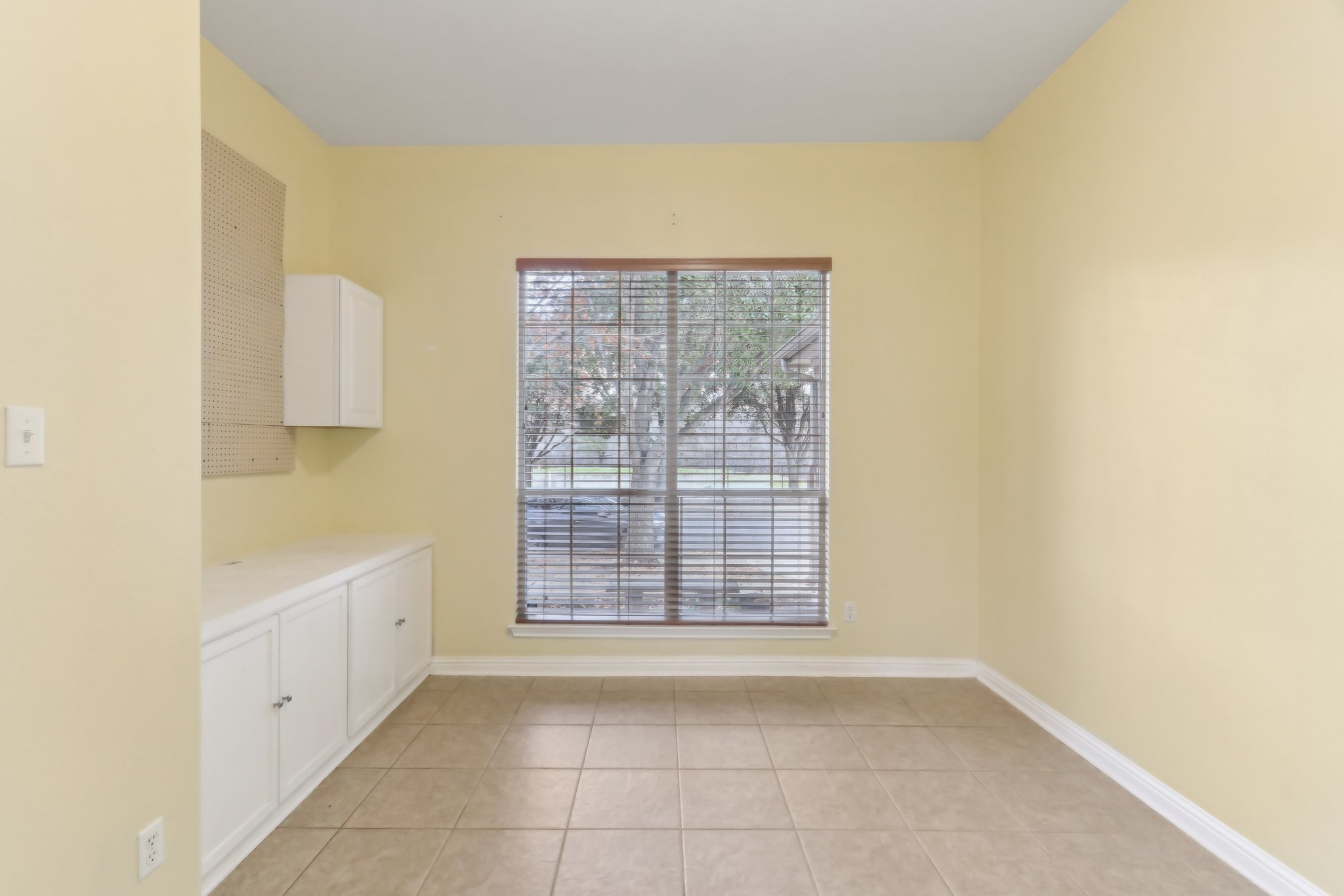 10108 Channel Island Drive Austin, TX 78747 - Photo 16 of 36 Unfurnished dining area featuring light tile patterned floors and baseboards