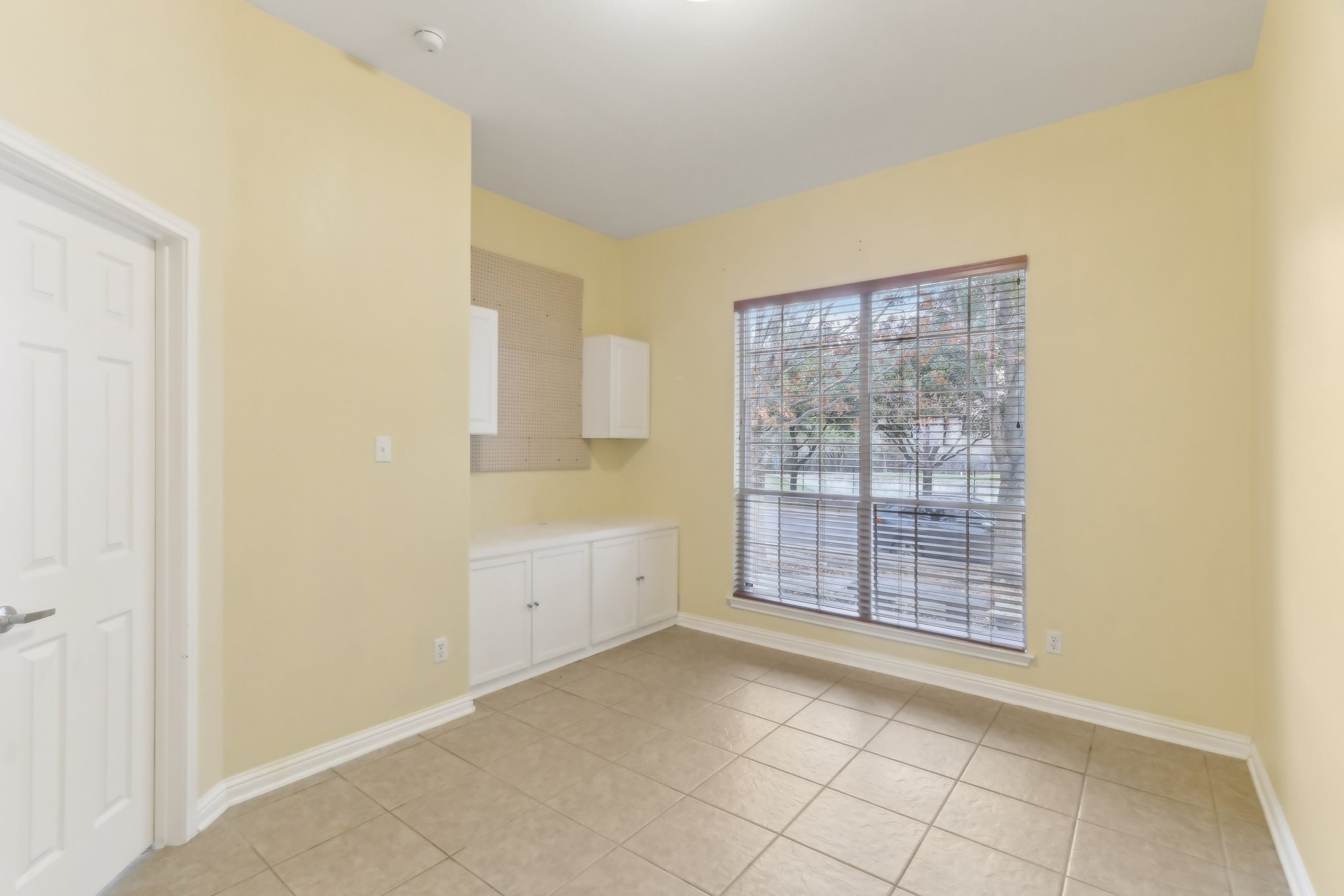 10108 Channel Island Drive Austin, TX 78747 - Photo 17 of 36 Unfurnished dining area with baseboards and light tile patterned flooring