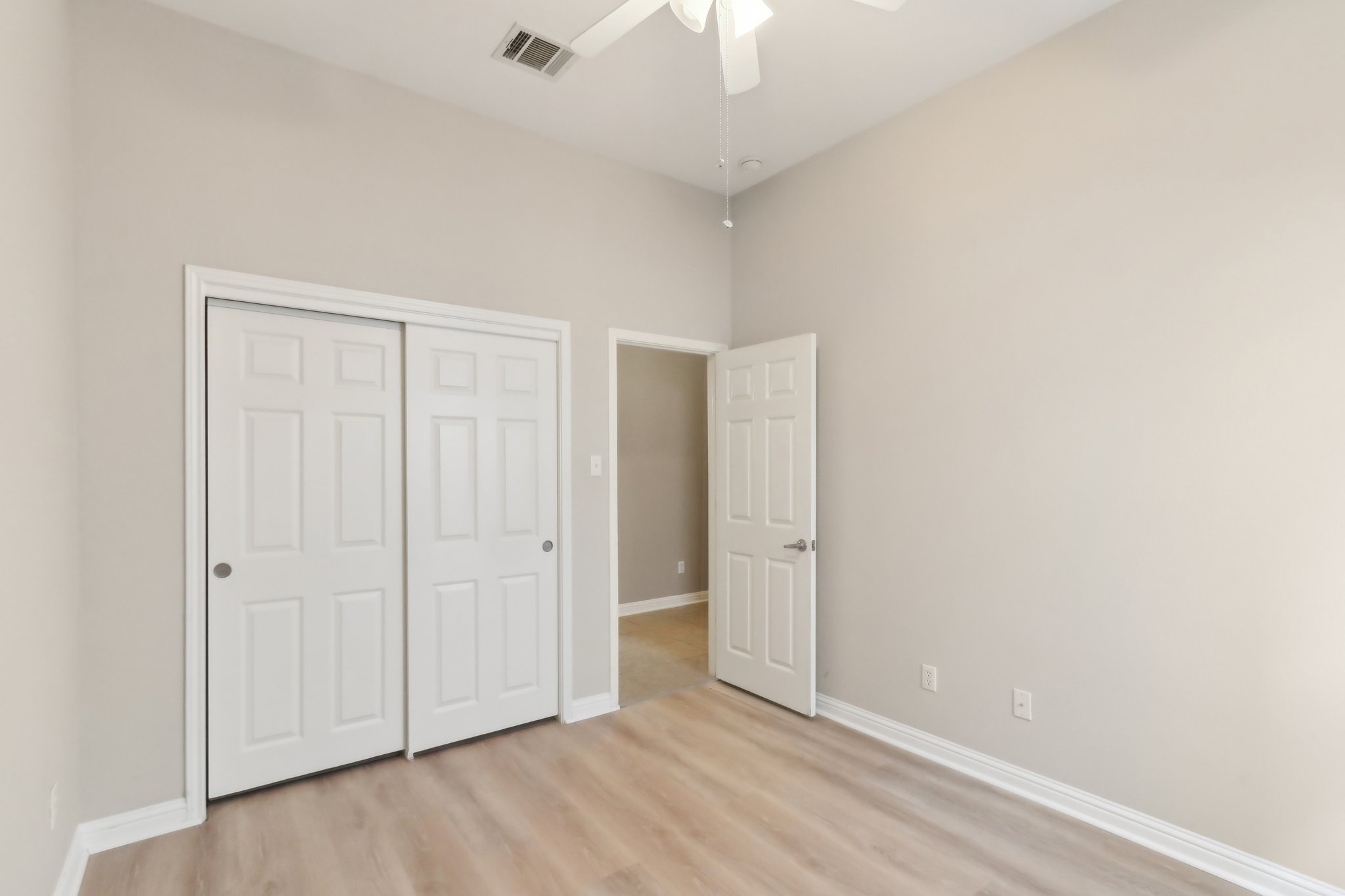10108 Channel Island Drive Austin, TX 78747 - Photo 23 of 36 Unfurnished bedroom featuring light wood-style floors, ceiling fan, and a closet
