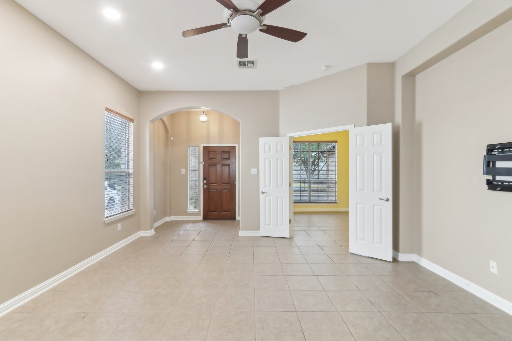 10108 Channel Island Drive Austin, TX 78747 - Photo 3 of 36 Entrance foyer with arched walkways, a ceiling fan, light tile patterned floors, and recessed lighting