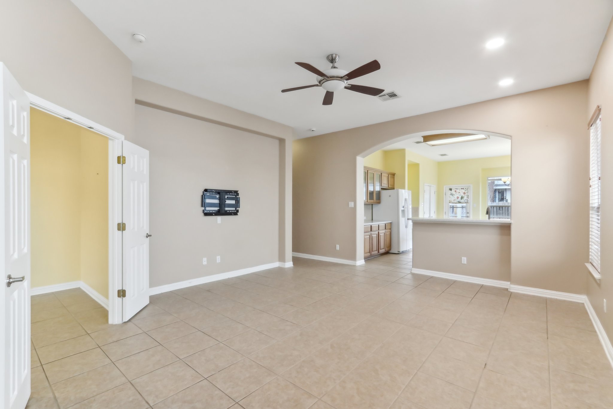 10108 Channel Island Drive Austin, TX 78747 - Photo 4 of 36 Spare room with a ceiling fan, arched walkways, and light tile patterned flooring