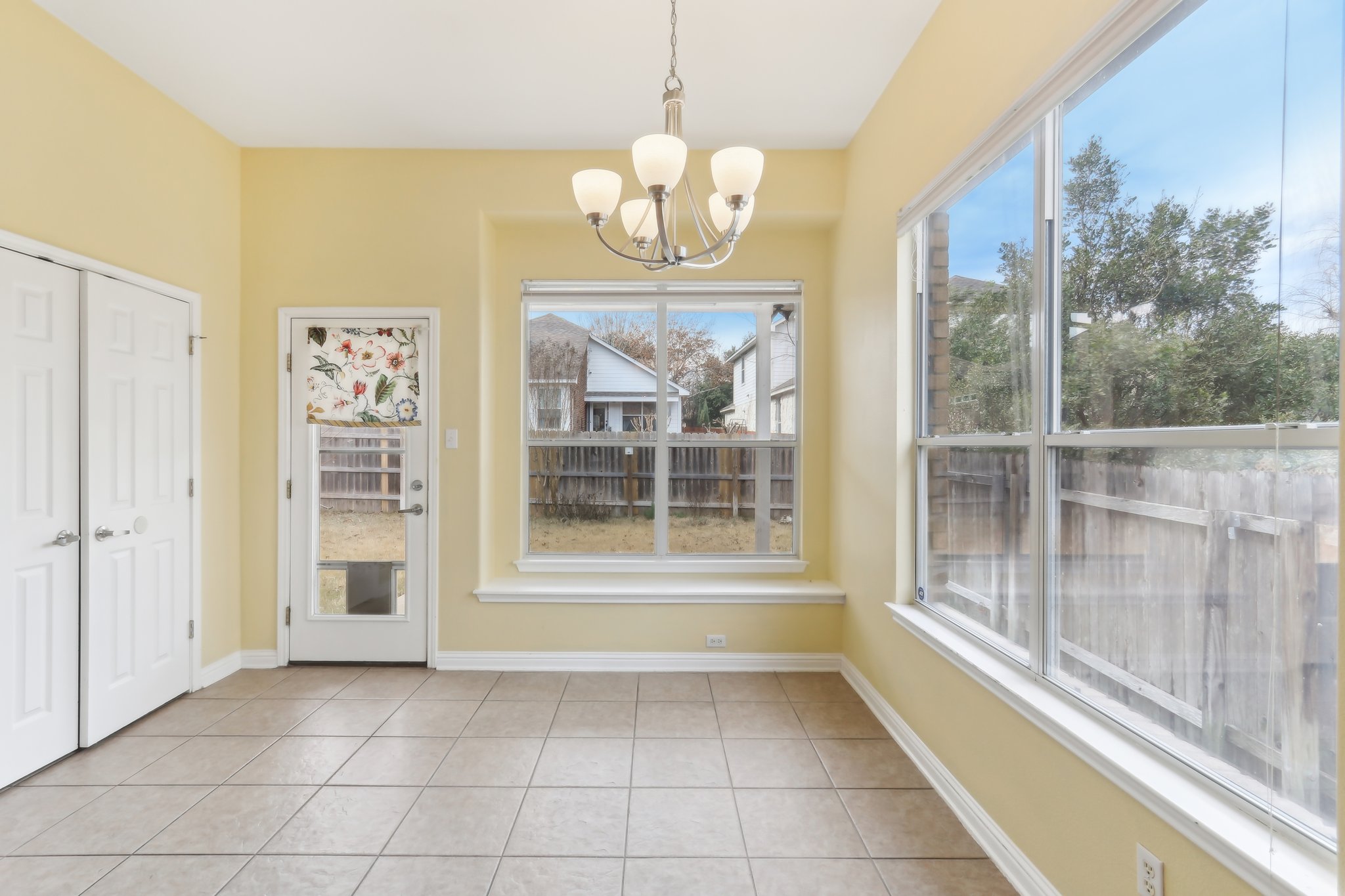 10108 Channel Island Drive Austin, TX 78747 - Photo 8 of 36 Unfurnished dining area with hanging lights and light tile patterned floors