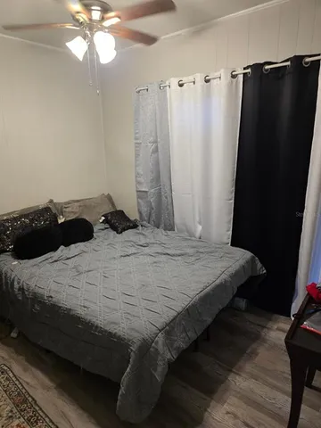 a bedroom with a bed and a mirror