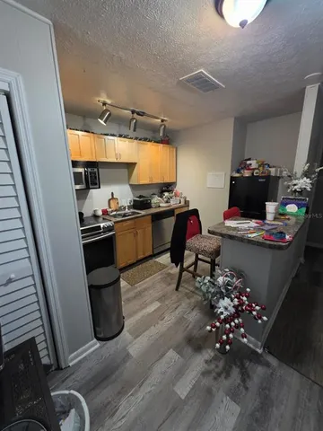 a room with a wooden floor and a sink