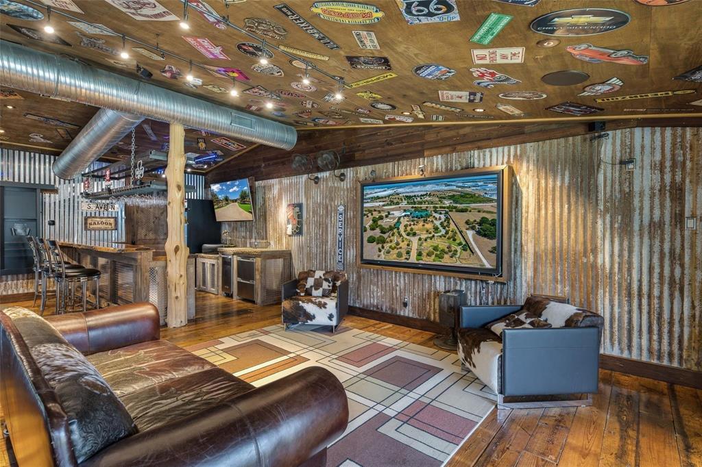 14250 Chaparral Lane Roanoke, TX 76262 - Photo 21 of 40 a living room with furniture and a flat screen tv