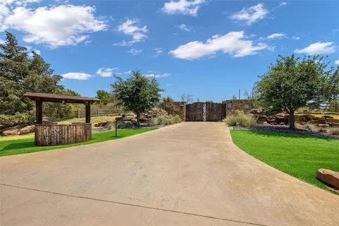 a view of a house with yard and sitting area