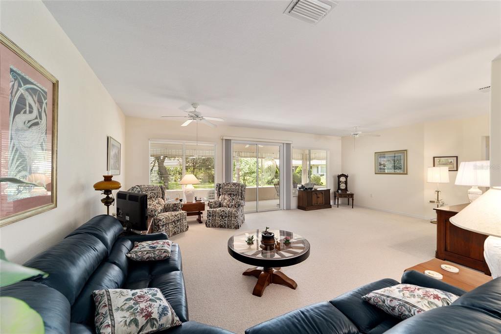 12896 Southeast 91st Terrace Road Summerfield, FL 34491 - Photo 12 of 77 a living room with furniture and a large window