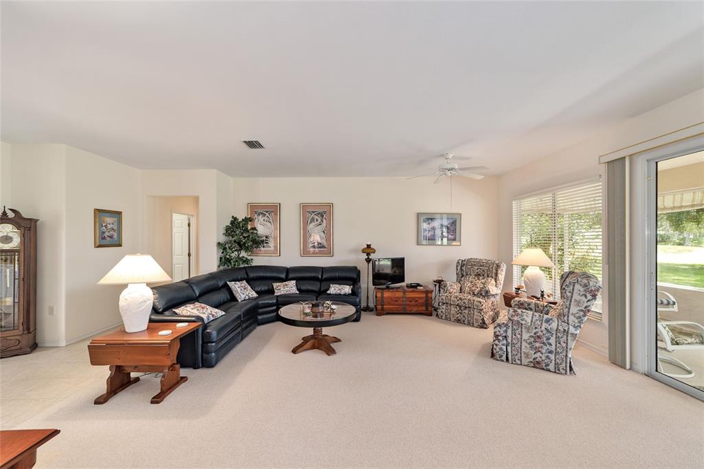 12896 Southeast 91st Terrace Road Summerfield, FL 34491 - Photo 13 of 77 a living room with furniture fireplace and a large window