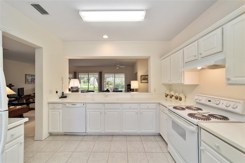 12896 Southeast 91st Terrace Road Summerfield, FL 34491 - Photo 20 of 77 a kitchen with a stove sink and cabinets