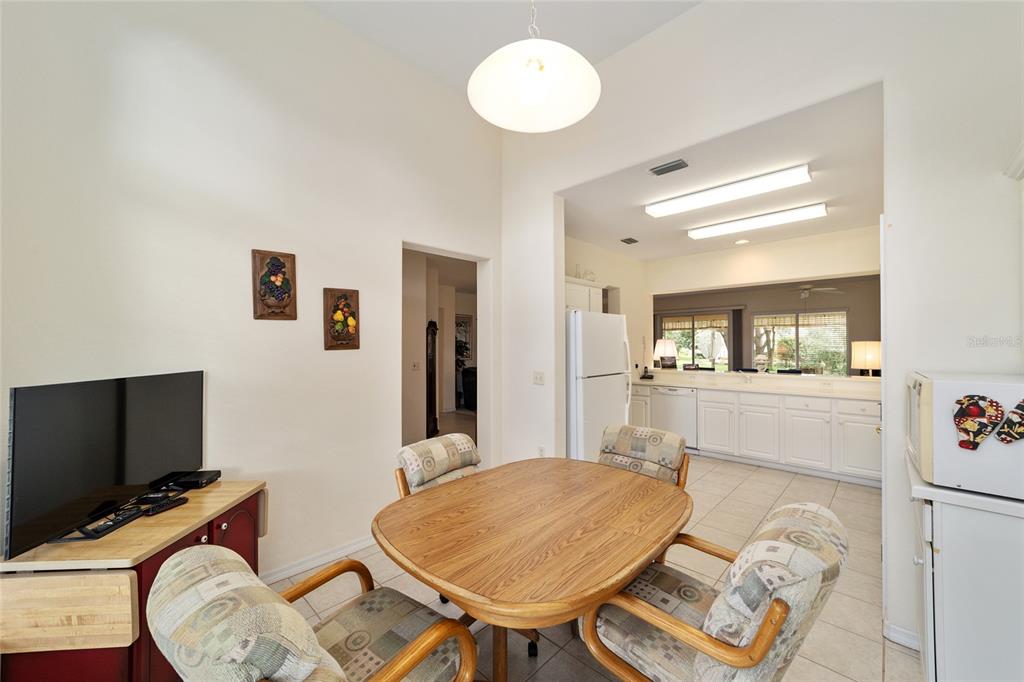 12896 Southeast 91st Terrace Road Summerfield, FL 34491 - Photo 23 of 77 a dining room with furniture and a flat screen tv