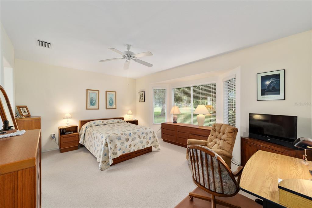 12896 Southeast 91st Terrace Road Summerfield, FL 34491 - Photo 24 of 77 a bedroom with a bed and a couch