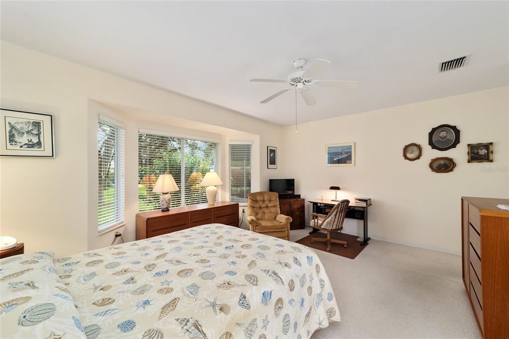 12896 Southeast 91st Terrace Road Summerfield, FL 34491 - Photo 25 of 77 a bedroom with a bed and wooden floor
