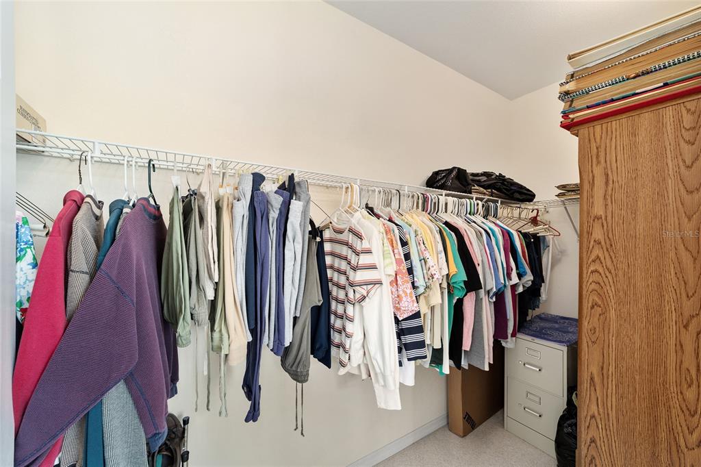 12896 Southeast 91st Terrace Road Summerfield, FL 34491 - Photo 30 of 77 a view of walk in closet with clothes and shoes