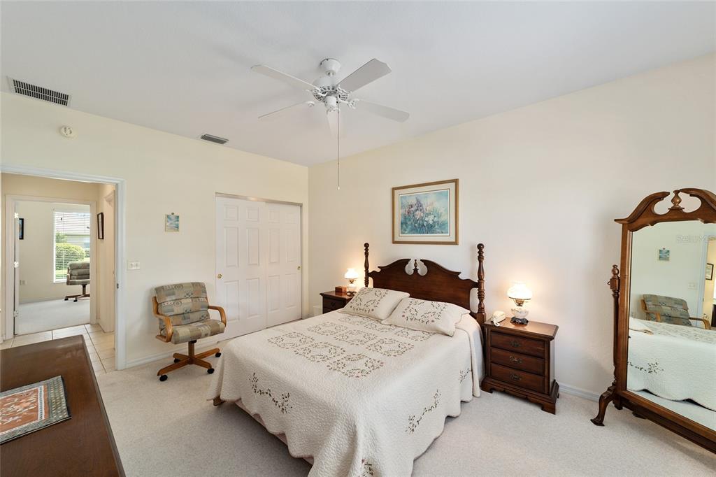 12896 Southeast 91st Terrace Road Summerfield, FL 34491 - Photo 32 of 77 a bedroom with a bed and a mirror